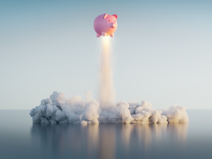 A piggy bank flying like a rocket