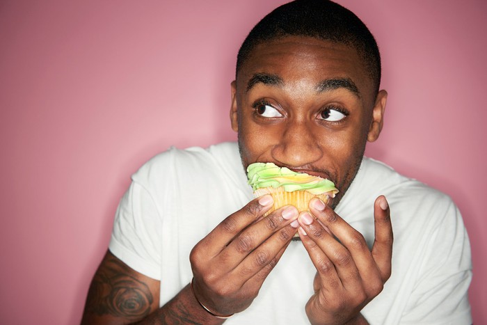 The man is eating a cake