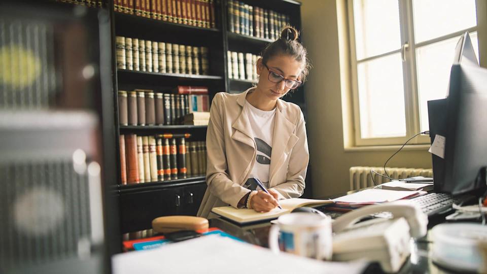 A young secretary with glasses in the library.