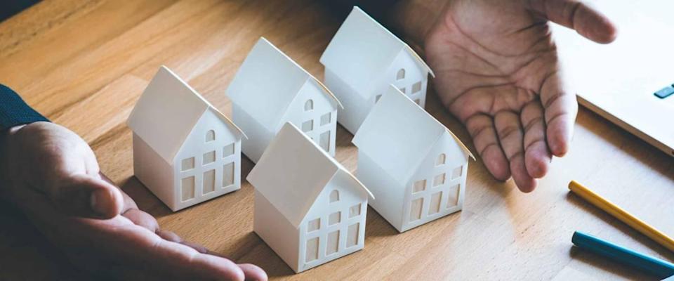 Business real estate, real estate and investment concepts with an investor and a white model on a background of pastel colors.